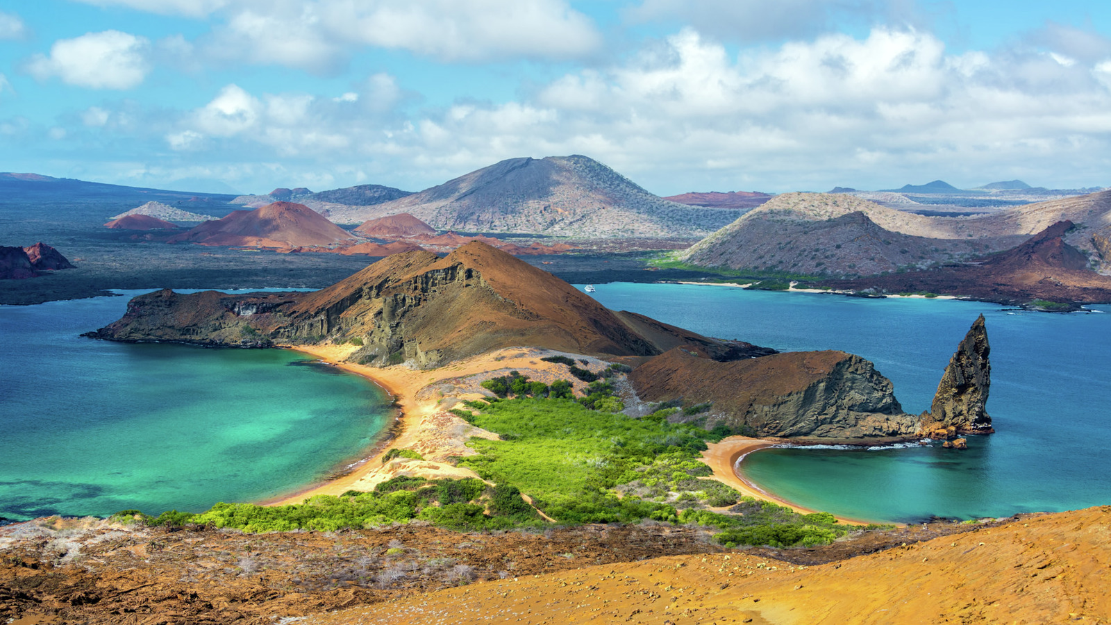 Vue panoramique officielle HX de l’île Bartolomé aux Galápagos, entre reliefs volcaniques et eaux turquoise.